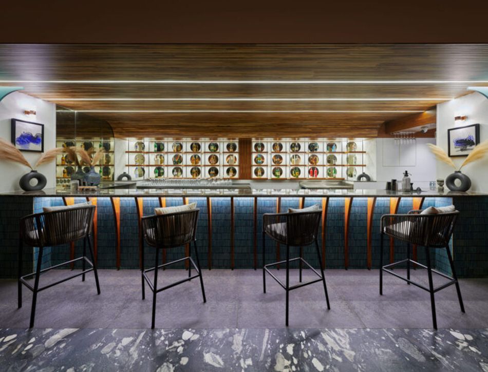 Anjuna bar — dark wood ceiling, blue tile counter