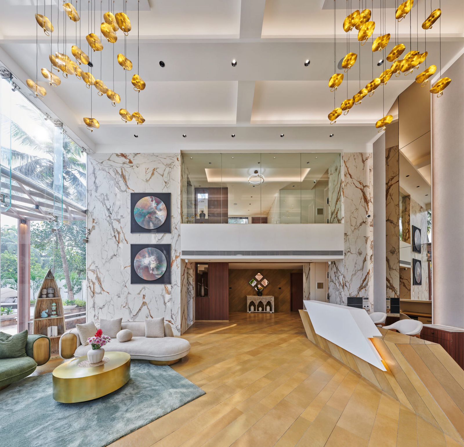 Anjuna lobby — gold-bauble chandeliers, marble reception